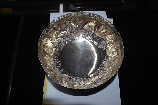An early 20th century Chinese white metal pedestal bowl, embossed with dragons, 13.5 oz.